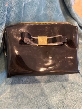 Ted Baker Patent Bow Cosmetic Clutch in Black with Gold Accent